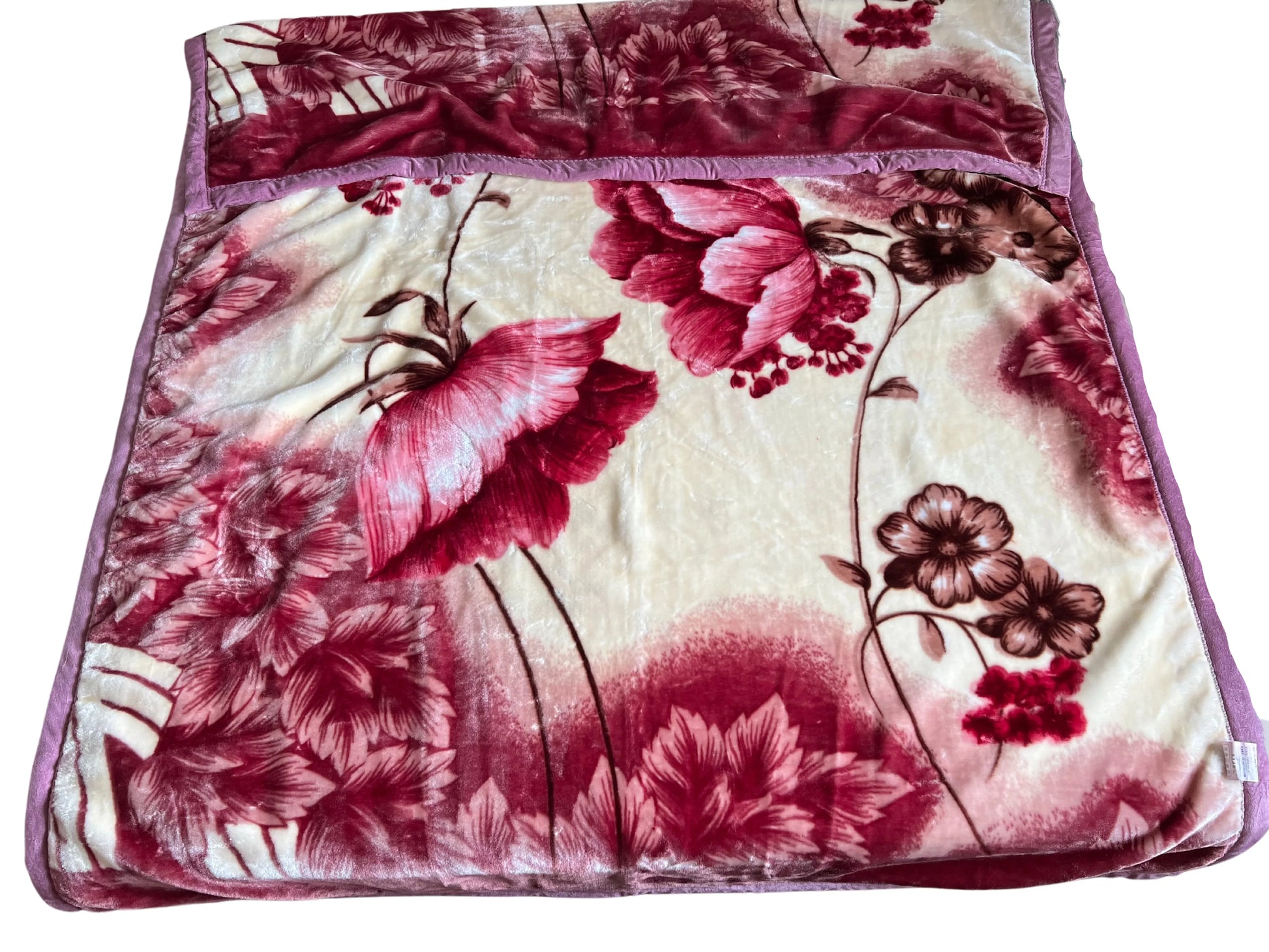 SilkenWarmth Raschel blanket, large floral motif, draped over an accent chair